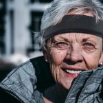 Protective headband by Forcefield® worn by an older woman, designed for athletes and high-risk activities to add a layer of head protection during exercise or recreational sports.