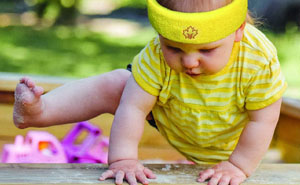 Child wearing a yellow protective headband outdoors, demonstrating safety during play, ideal for children in high-risk activities or sports requiring head protection.